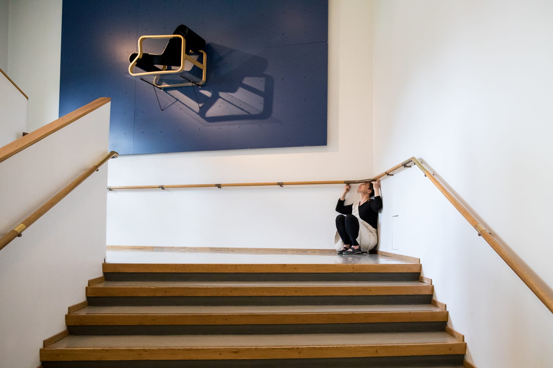 Dancer on the floor in a corner of a building.